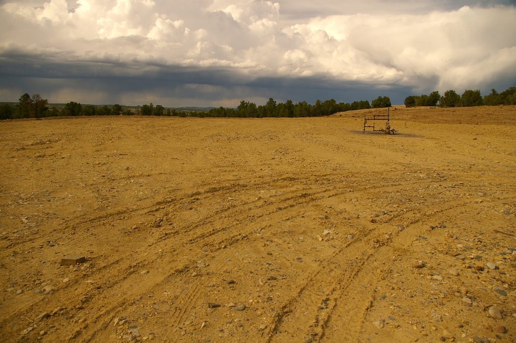 Homogenized bare soil surrounds a wellhead on a typical natural gas well pad that has been prepared for interim reclamation. Credit, Tamera Minnick.