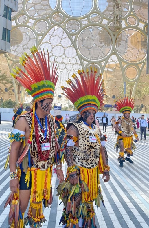 Native head dresses worn by two men.