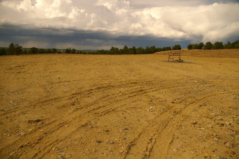 Homogenized bare soil surrounds a wellhead on a typical natural gas well pad that has been prepared for interim reclamation. Credit, Tamera Minnick.