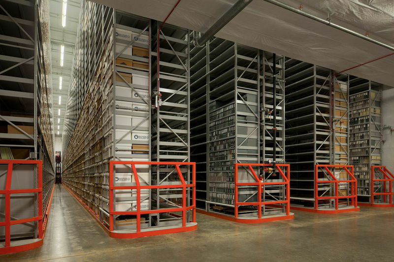 Rows of archived documents fill a warehouse.