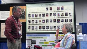 Jean Langenheim stands by a poster at an ESA annual meeting and discusses it with someone.