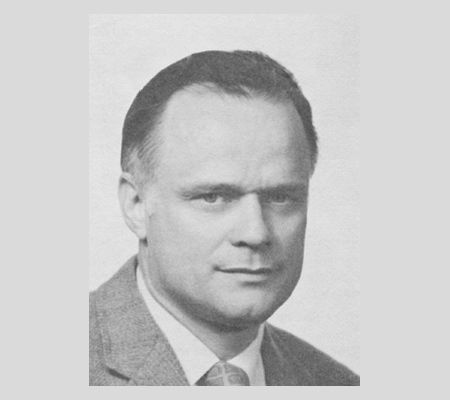 Portrait image of F.H. Bormann in a coat and tie. Black and white photo.
