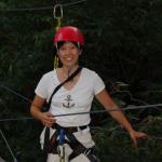 Portrait image of Dr. Mimi Lam who is in climbing gear including a red protective helmet.