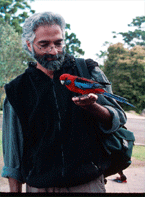 Portrait image of Shahid Naeem with a bird on his extended hand.