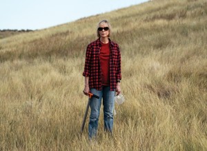 Diana Wall poses for a portrait in an open semi-arid field.