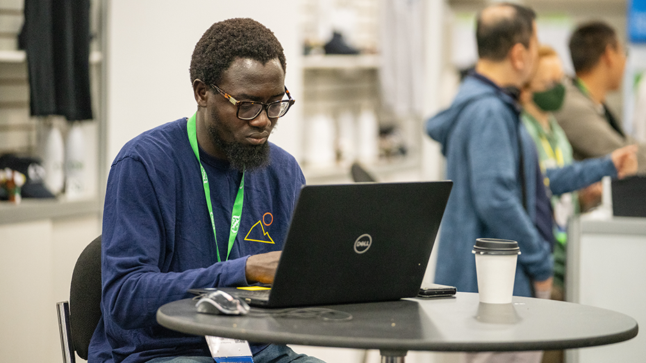 An attendee participates on their laptop.