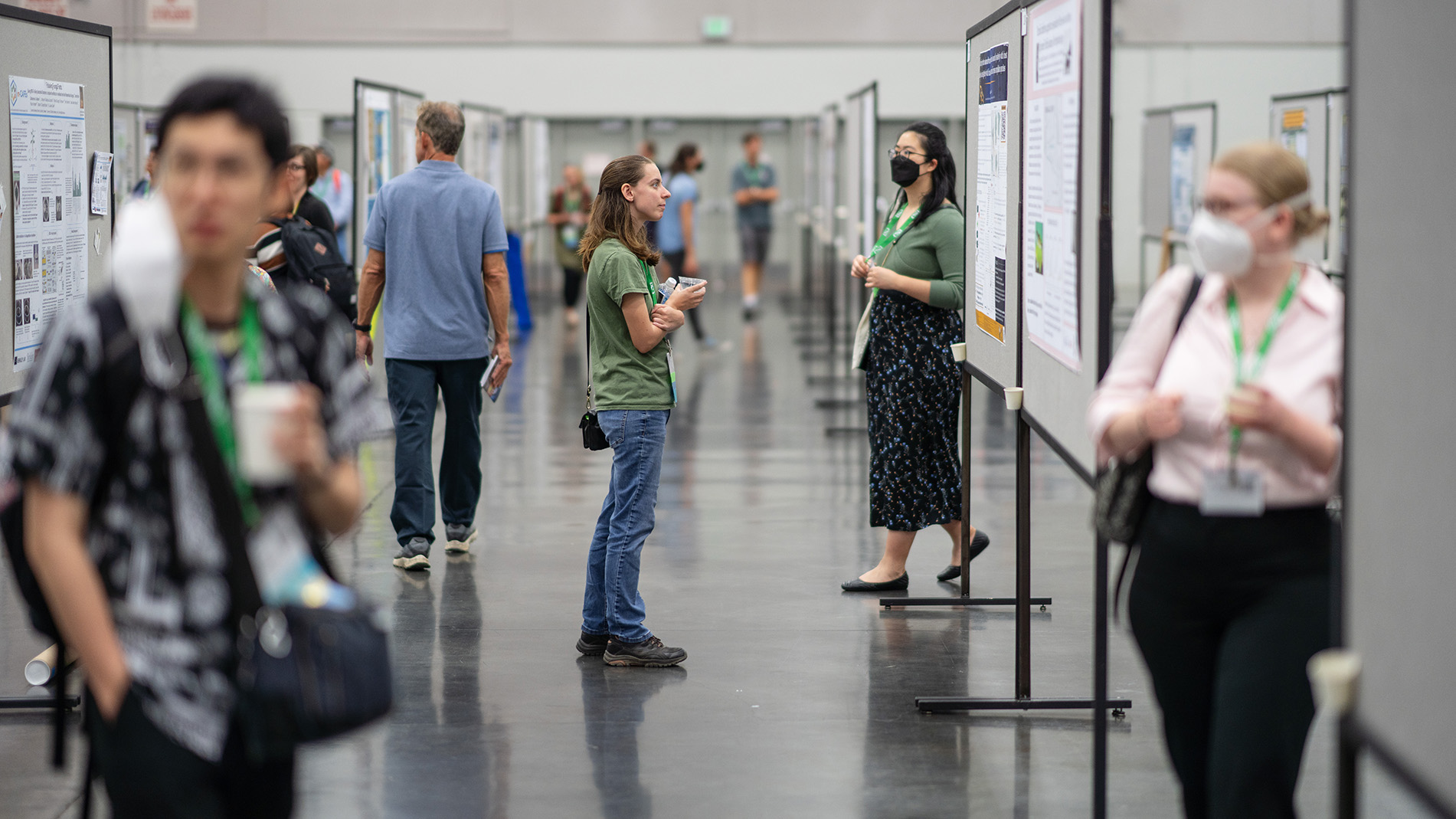 A poster presenter discusses a topic.