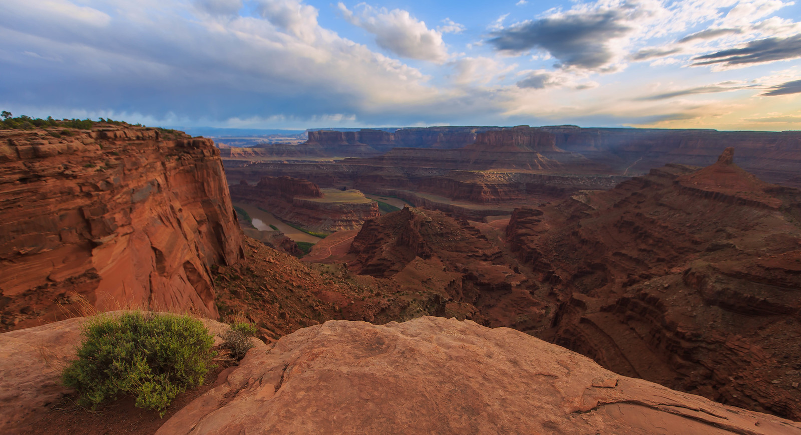 A view from atop a red clay colored canyon top.