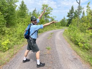 an intern points off in the distance towards Isle Royale